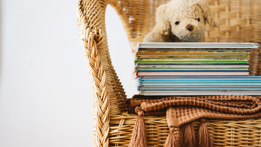Stack of books for reading to baby in NICU with teddy bear